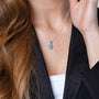 Blue Opal Cross Pendant Necklace, Silver Bezel Frame, 925 Sterling Silver – shown worn, close-up