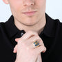 Gold-plated Jerusalem Cross Eilat Stone signet ring in 925 sterling silver on a man's hand, close-up