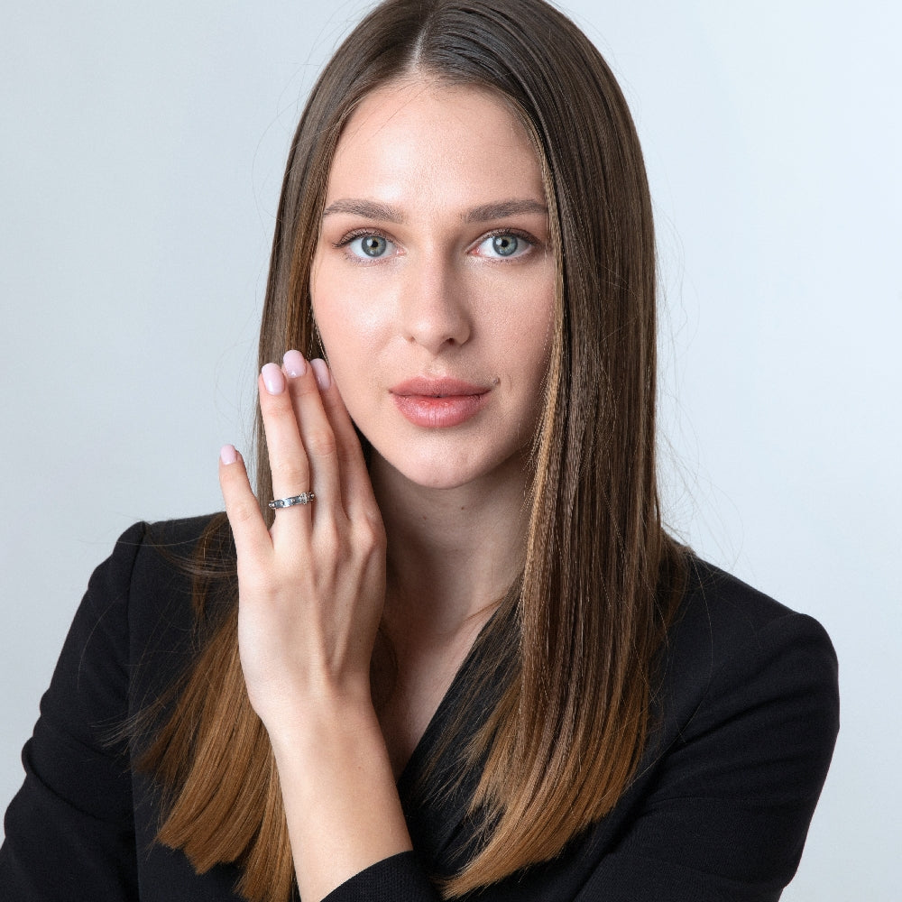 Woman in black wearing the sterling silver decade rosary ring