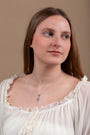 Looped Cross Pendant Necklace in 925 Sterling Silver, Marcasite – shown worn