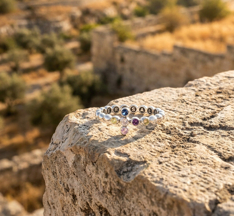 Beaded bracelet on a stone ledge above terraced hills
